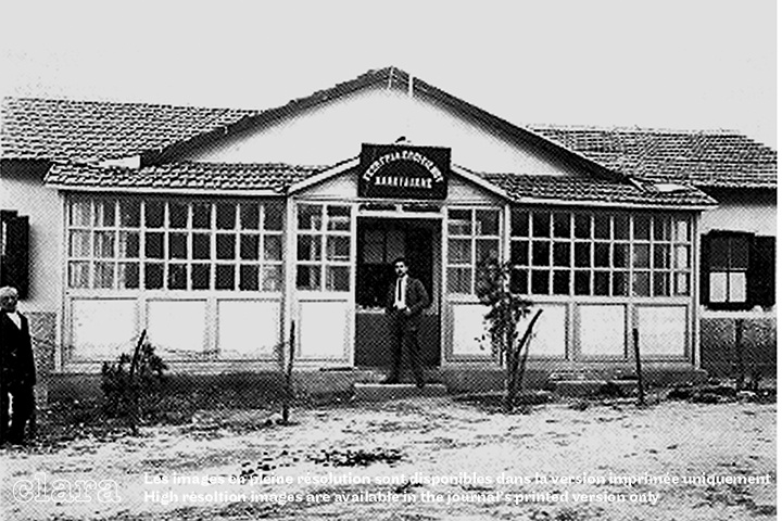 Image description generated by AI: Black and white photo of a single-story building with large windows and a sign reading "Rural Colonization Bureau."