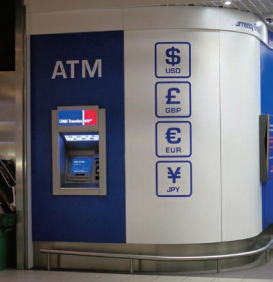 Description de l'image par IA : Distributeur automatique de billets avec options USD, GBP, EUR, JPY.