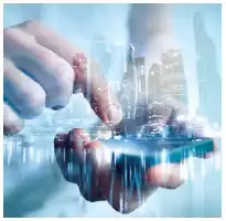 Description de l'image par IA : Deux mains interagissent avec une interface tactile holographique bleue, représentant une ville.