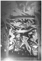 Description de l'image par IA : Murale en noir et blanc avec des figures stylisées et des étoiles, signé Jean-Charles de Castelbajac.